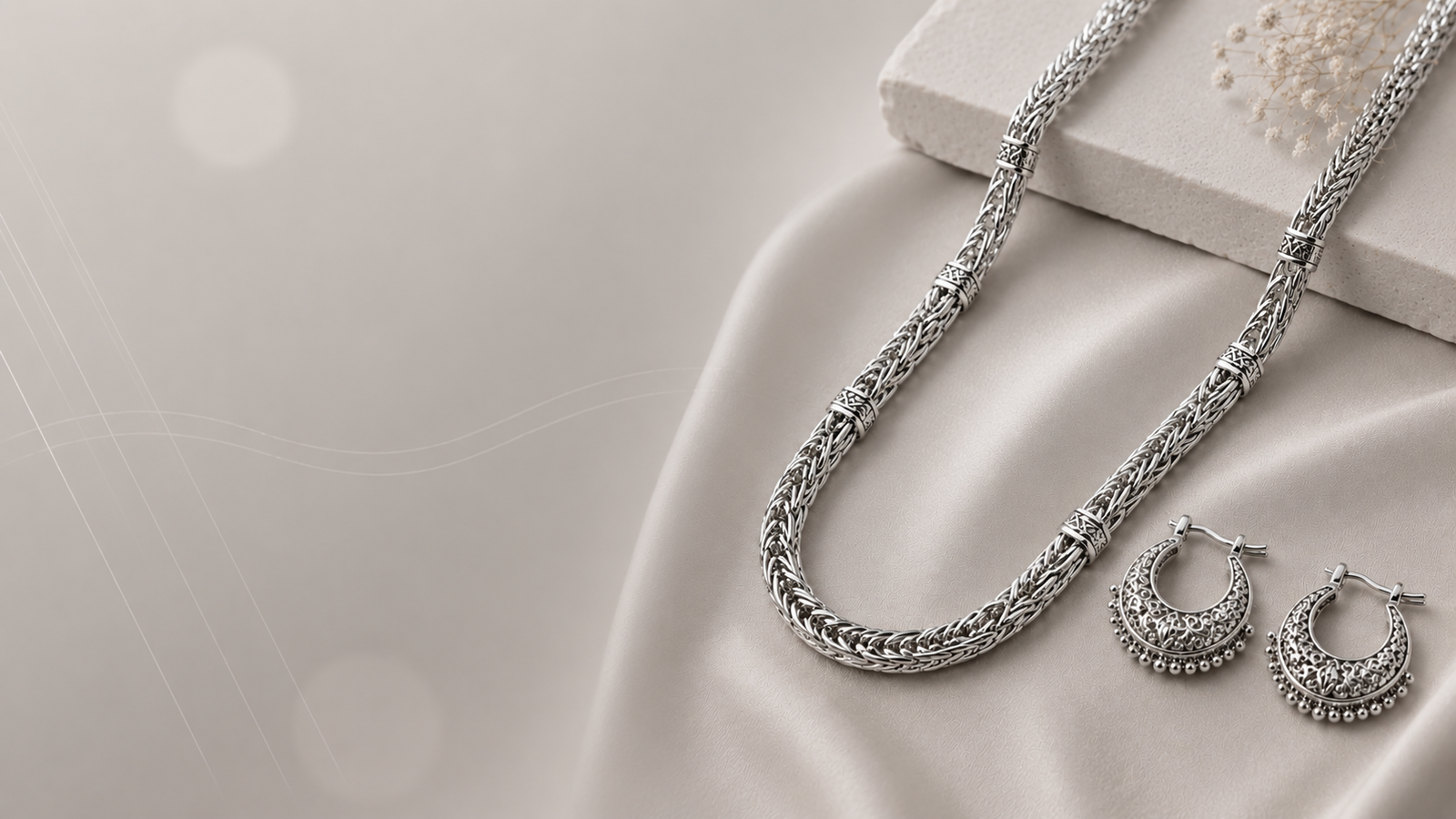 Silver jewellery on soft stone and ivory silk